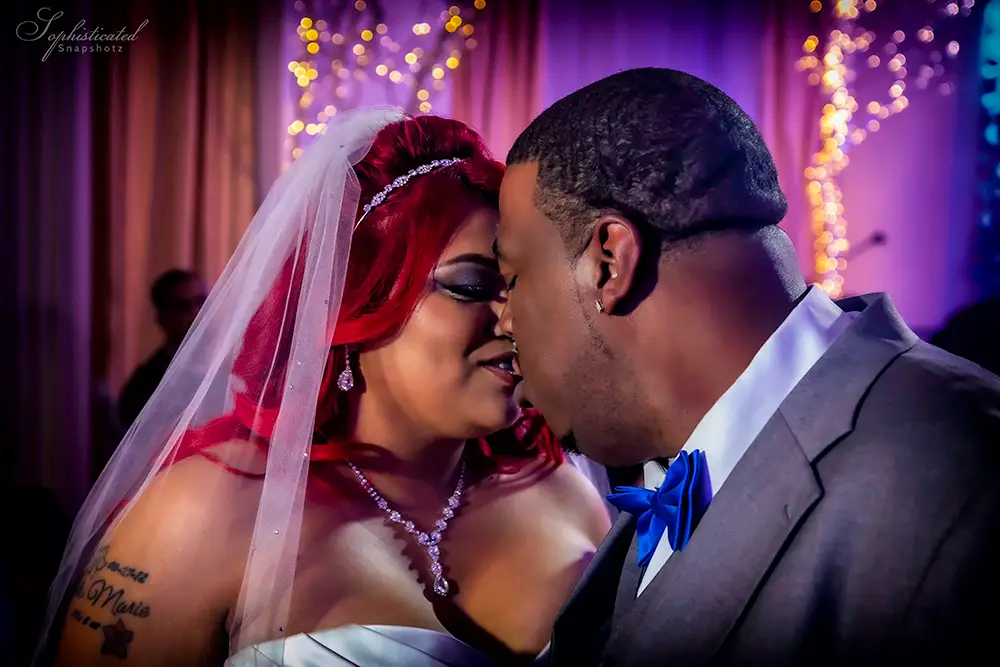 Bride and groom sharing a close moment, with the bride wearing a veil and the groom in a suit.